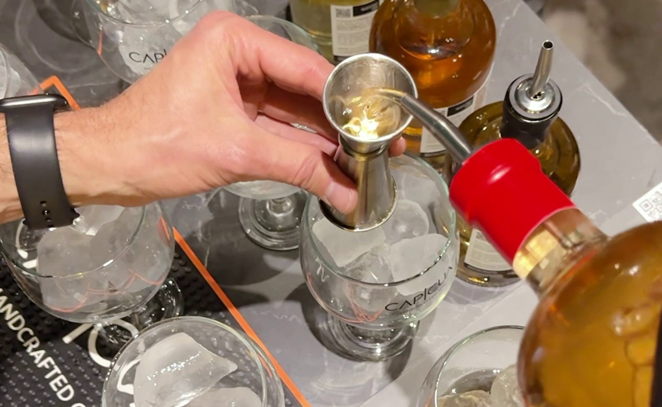 Servicio de CAPICÚA medido con jigger sobre una copa con hielo